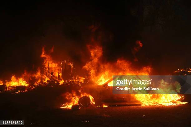 Car burns as the Kincade Fire moves through the area on October 24, 2019 in Geyserville, California. Fueled by high winds, the Kincade Fire has...