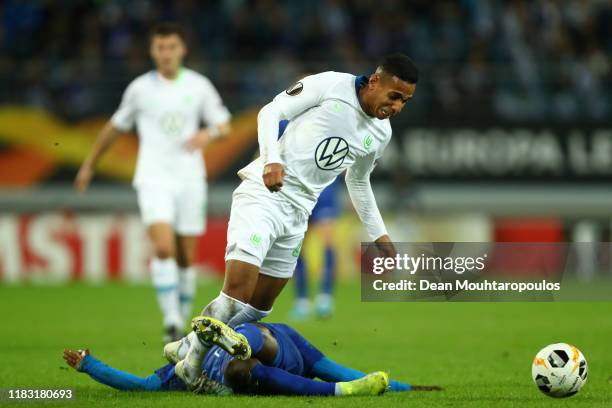 Nana Asare of Gent tackles Joao Victor of VfL Wolfsburg during the UEFA Europa League group I match between KAA Gent and VfL Wolfsburg at Ghelamco...