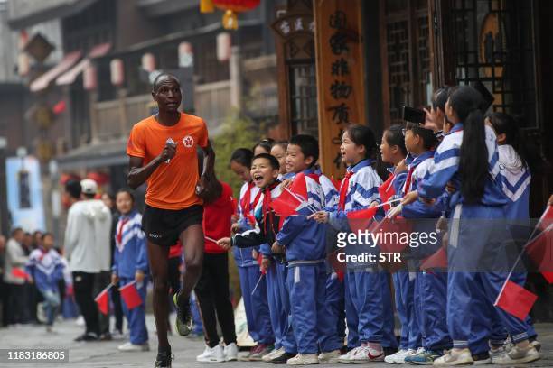 This photo taken on November 17, 2019 shows a runner taking part in the Guizhou Tour of Leigong Mountain 100km International Marathon in Danzhai in...