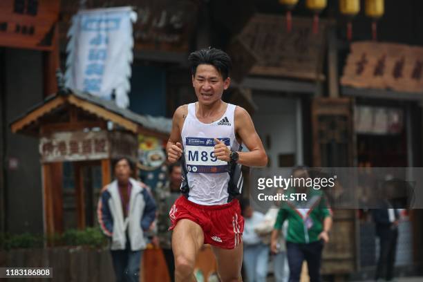 This photo taken on November 17, 2019 shows a runner taking part in the Guizhou Tour of Leigong Mountain 100km International Marathon in Danzhai in...