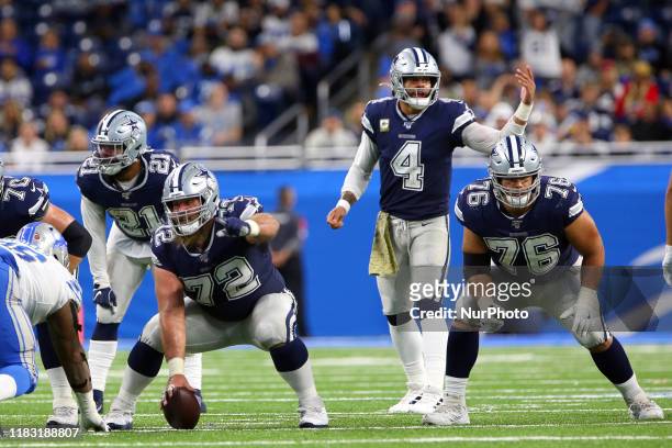 Dallas Cowboys center Travis Frederick and Dallas Cowboys quarterback Dak Prescott call a play at the line of scrimmage during the second half of an...
