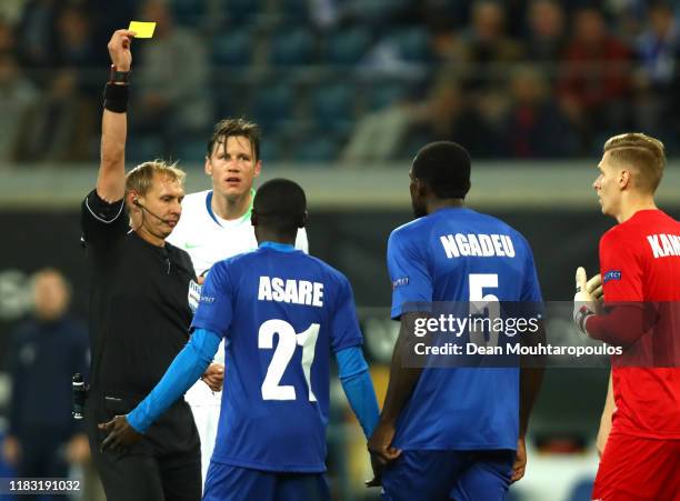 Nana Asare of Gent is shown a yellow card by referee Sergei Ivanov during the UEFA Europa League group I match between KAA Gent and VfL Wolfsburg at...