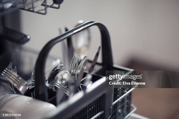 cutlery in a dishwasher - spülmaschine stock-fotos und bilder