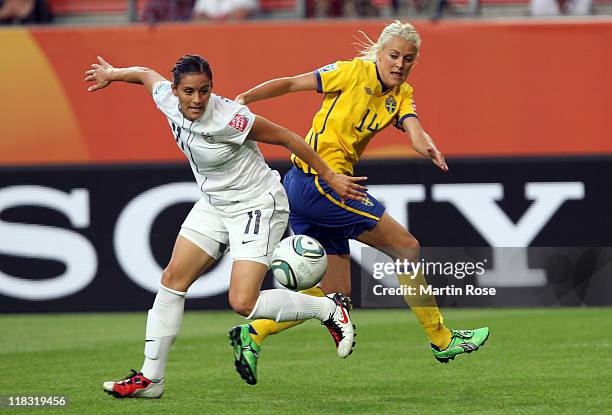 Josefine Oqvist of Sweden and Alex Krieger of USA battle for the ball during the FIFA Women's World Cup 2011 Group C match between Sweden and USA at...