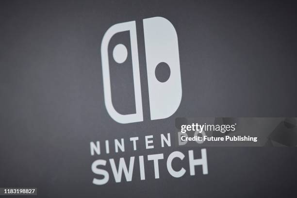 Close-up detail of the logo on the back of a 2019 Nintendo Switch Lite handheld video games console with a Gray finish, taken on November 7, 2019.