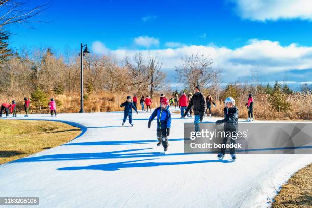 people ice skate in a park - etobicoke ontario stock pictures, royalty-free photos & images