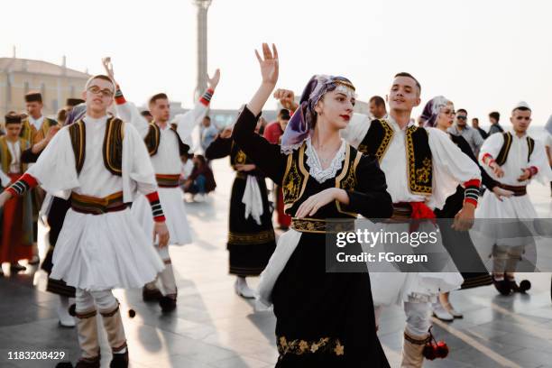 people dancing in balkan traditional clothing at the festival - folk music festival stock pictures, royalty-free photos & images