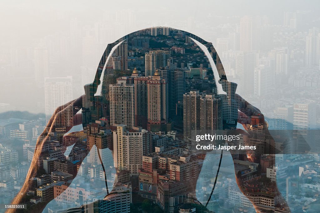Double exposure of man listening to head phones an