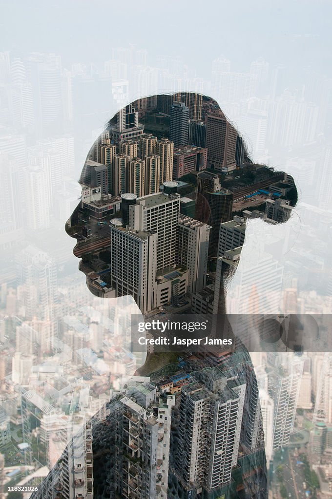 Double exposure of woman and cityscape