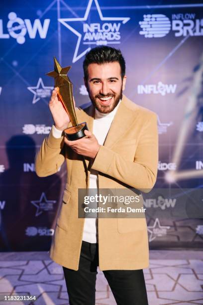 Selcuk Buyuk poses with his award Best Rising Influencer during the Inflow Global Awards 2019 at the Four Seasons Bosphorus Hotel on October 22, 2019...