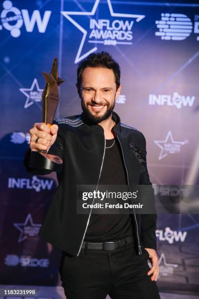 Ozgun poses with his award Best Social Responsibility Influencer Campaign during the Inflow Global Awards 2019 at the Four Seasons Bosphorus Hotel on...