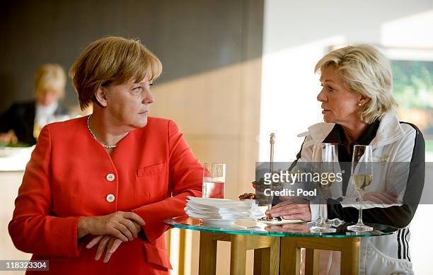 In this photo provided by the German Government Press Office, German Chancellor Angela Merkel speaks to head coach of Germany Silvia Neid during her...