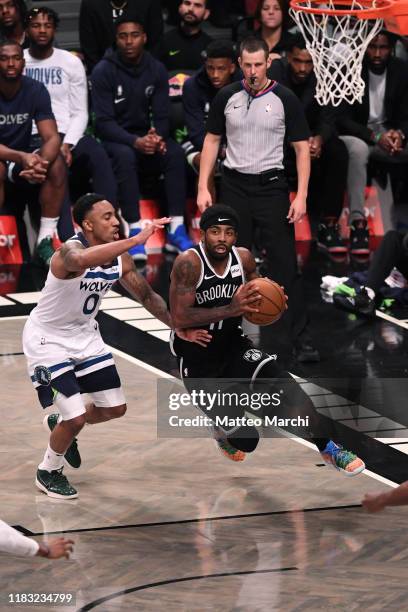 Kyrie Irving of the Brooklyn Nets handles the ball against Jeff Teague of the Minnesota Timberwolves during the game at Barclays Center on October...