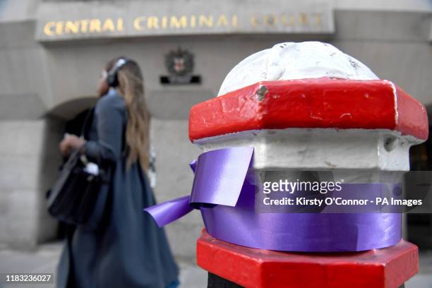 Purple ribbon, tied to a post outside the Old Bailey in London in memory of murdered 17-year-old Girl Scout Jodie Chesney. Svenson Ong-a-Kwie, 19 and...