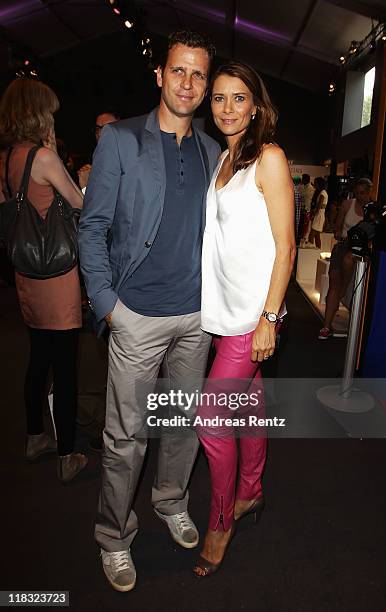 Oliver and Klara Bierhoff sit in front row at the Strenesse Blue Show during Mercedes-Benz Fashion Week Berlin Spring/Summer 2012 at the Brandenburg...