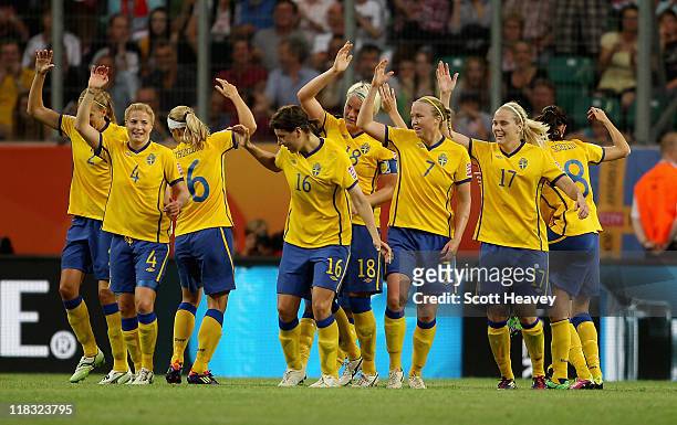 The Sweden team celebrate after scoring their second goal during the FIFA Women's World Cup 2011 Group C match between Sweden and USA at the Arena In...