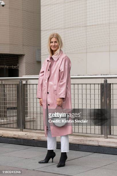 Fashion and beauty editor at Harper's Bazaar Netherlands Simone Sniekers wears Celine boots, Kassl trench, Wandler bag and Goldsign pants on...