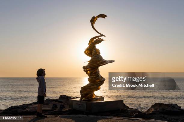 Young boy views the sculpture by Wang Kaifang, The Statue of Mad Liberty, at Sculpture By The Sea at Bondi Beach on October 25, 2019 in Sydney,...