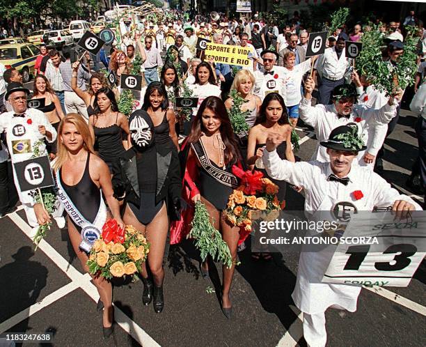 Brazilians in Rio de Janeiro march in a parade to celebrate Fiday the 13th. Xerife , presidente de la Cofradia do Garoto abre el desfile junto a las...