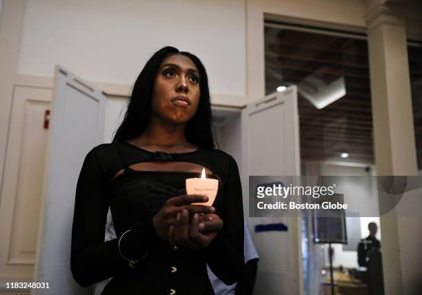 Chanel Kennerly holds a candle during a vigil for the Transgender Day of Remembrance at The Cathedral Church of St. Paul in downtown Boston on Nov....