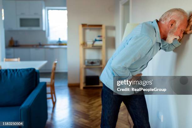 man hand holding on middle crotch of trousers - bladder weakness stock pictures, royalty-free photos & images