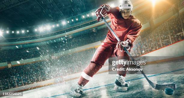 ice hockey player in action - ice hockey player stock pictures, royalty-free photos & images