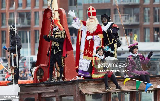Dutch people dressed as Black Pete, Saint-Nicholas helpers, and a man dressed as Saint-Nicholas arrive by boat during the traditional Saint-Nicholas...