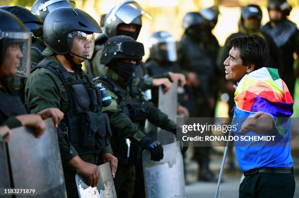 Supporter of Bolivian ex-President Evo Morales faces riot police during a demonstration in Cochabamba, on November 18, 2019. Bolivia's influential...