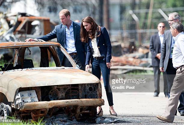 Prince William, Duke of Cambridge and Catherine, Duchess of Cambridge inspect a fire-damaged car in a part of town devastated by a fire in May 2011,...