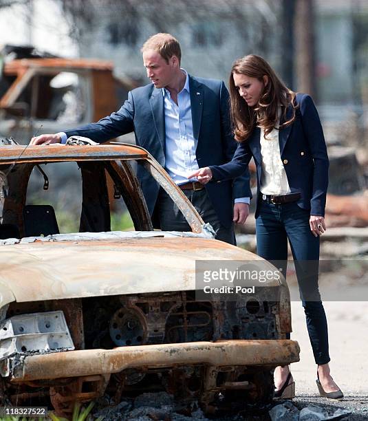 Prince William, Duke of Cambridge and Catherine, Duchess of Cambridge inspect a fire-damaged car in a part of town devastated by a fire in May 2011,...