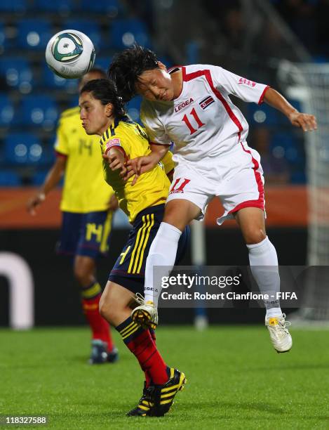 Diana Ospina of Colombia is challenged by Ri Ye Gyong of Korea DPR during the FIFA Women's World Cup 2011 Group C match between Korea DPR and...