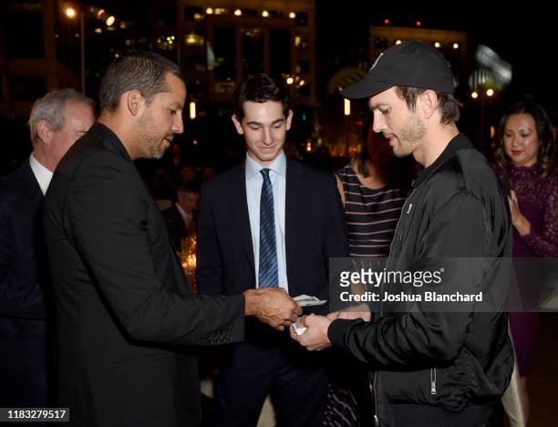David Blaine performs a magic trick with Ashton Kutcher during the Transformative Medicine of USC: Rebels with a Cause GALA at on October 24, 2019 in...