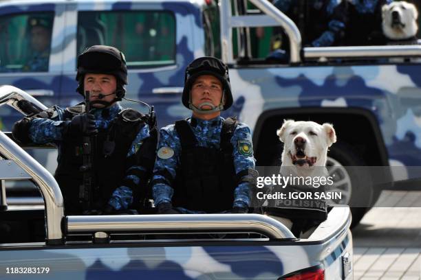 Police alabai shepherd dogs are seen riding in trucks during a military parade in central Ashgabat on September 27 on the 28th anniversary of...