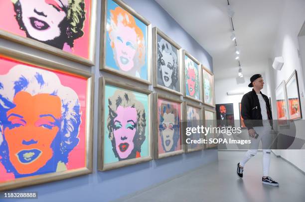 Visitor walks by graphics art works of Marilyn Monroe by Andy Warhol during the exhibition. Central Gallery presents chronological exhibitions of...