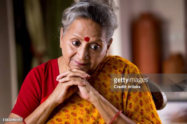 thoughtful senior woman - loneliness stock pictures, royalty-free photos & images