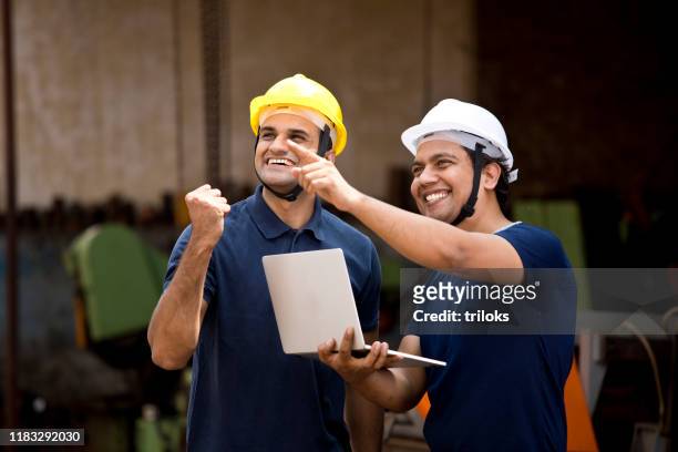 zwei männliche architekten feiern erfolg - indian engineer stock-fotos und bilder