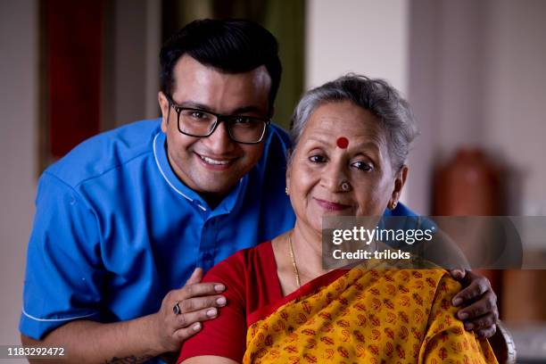 male nurse caring old woman at home - daily life in india stock pictures, royalty-free photos & images