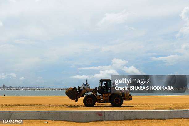 In this picture taken on November 8 a labourer works at the construction site on reclaimed land as part of the Chinese-funded project for Port City...