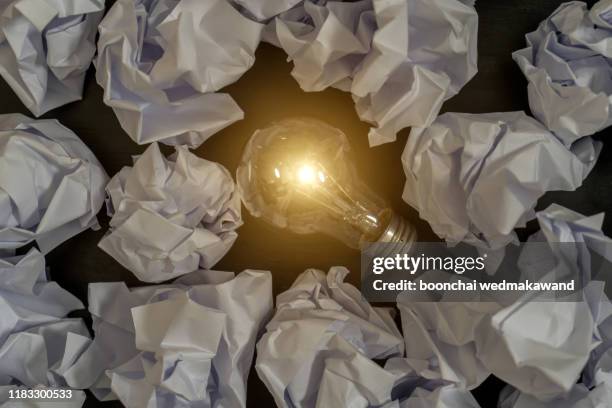 inspiration concept crumpled paper light bulb metaphor for good idea - paper ball stock-fotos und bilder