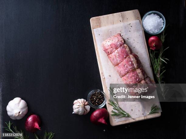high angle view of gourmet butchers lamb tenderloin. - black wood material stock pictures, royalty-free photos & images