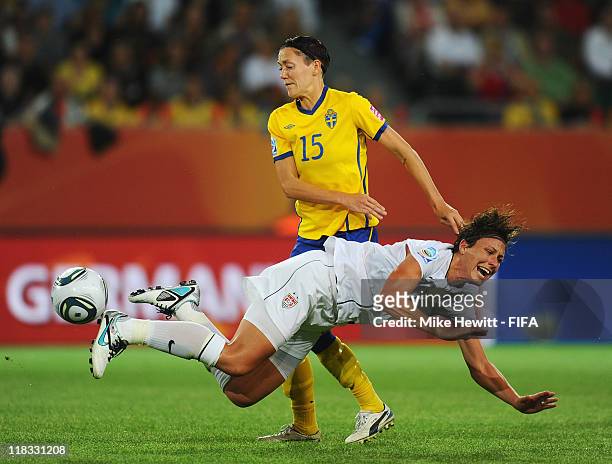 Abby Wambach of USA is fouled by Therese Sjogran of Sweden during the FIFA Women's World Cup 2011 Group C match between Sweden and USA at Arena IM...