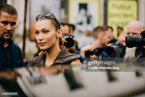 Model Bella Hadid after the Mugler show in the thin pointed eyebrows from the show by Inge Grognard and Chanel sunglasses during Paris Fashion Week...
