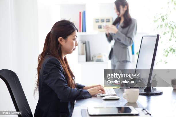 two women who is working in ther office and using the phone - file clerk stock pictures, royalty-free photos & images