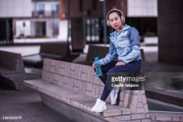 fit woman athlete resting outdoors. - hot vietnamese women stock pictures, royalty-free photos & images