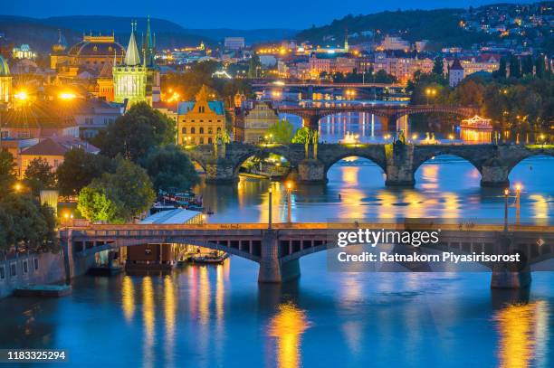 scenic spring sunset aerial view of the old town pier architecture and charles bridge over vltava river in prague, czech republic - karlsbrücke stock-fotos und bilder