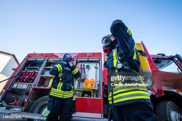 firefighters in fire-rescue operation - respirator mask stock pictures, royalty-free photos & images
