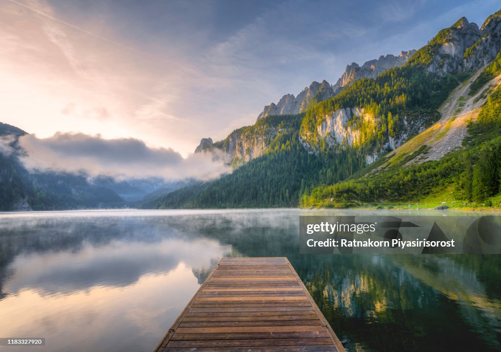 Fantastic Sunrise Scene with Fog Over Lake at azure alpine lake Vorderer Gosausee. Gosau valley in Upper Austria