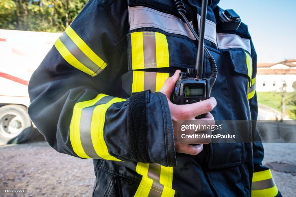 Firefighter using walkie talkie, rescue operation Close Up