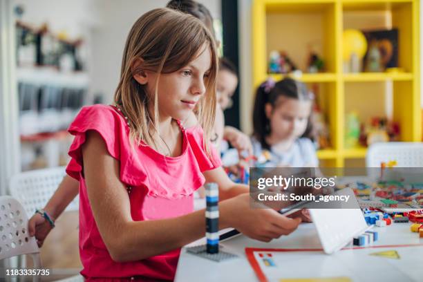 kids playing with toy cubes - public school building stock pictures, royalty-free photos & images