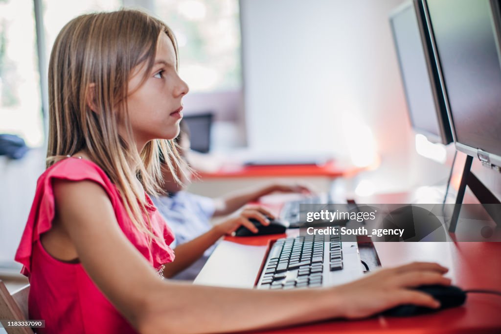 Cute Girl Elementary School Using Computer High-Res Stock Photo - Getty ...